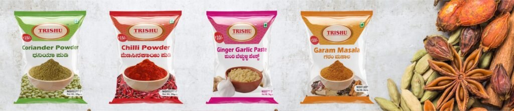 Four packets of Trishu spices including coriander powder, chilli powder, ginger garlic paste, and garam masala.